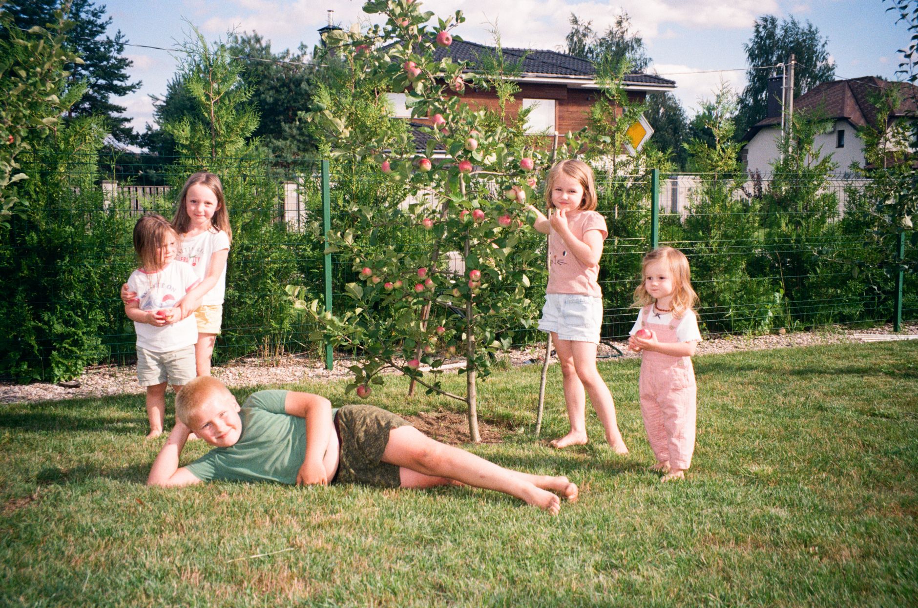 Children playing together in a sunlit garden